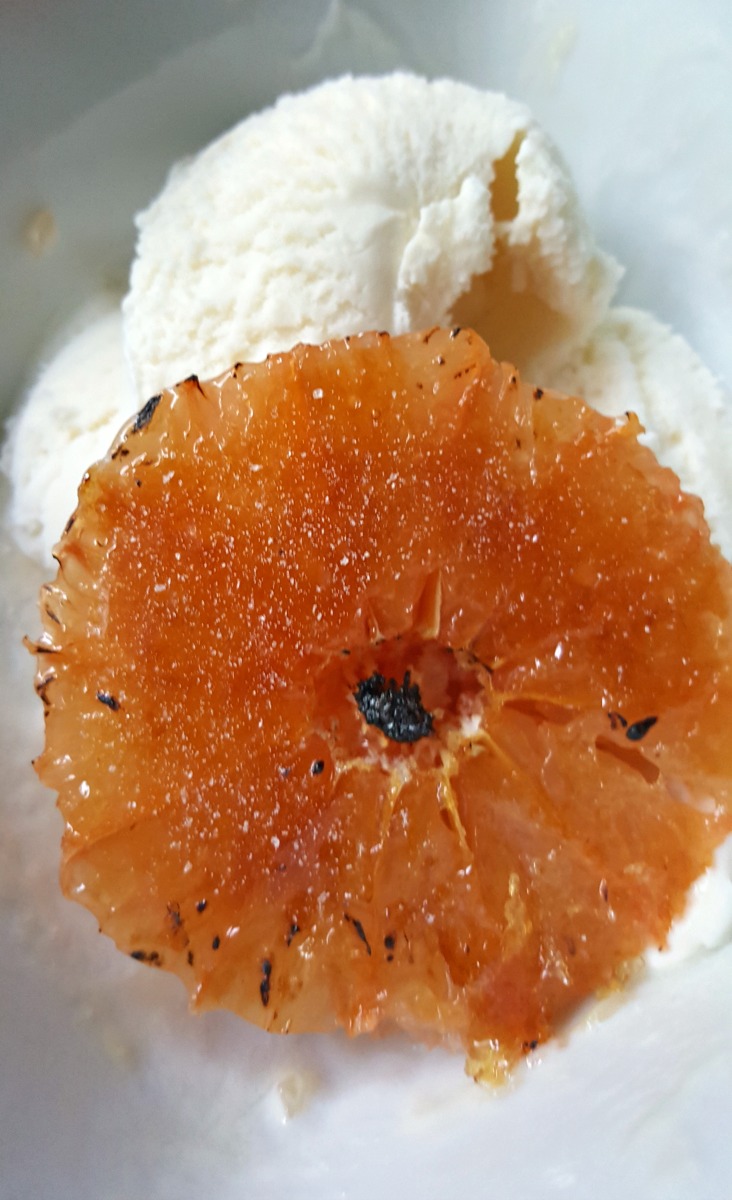 Grapefruit Brulee is sliced grapefruit with a burnt sugar crust made with a kitchen blow torch. Serve it over vanilla ice cream for a delicious dessert.