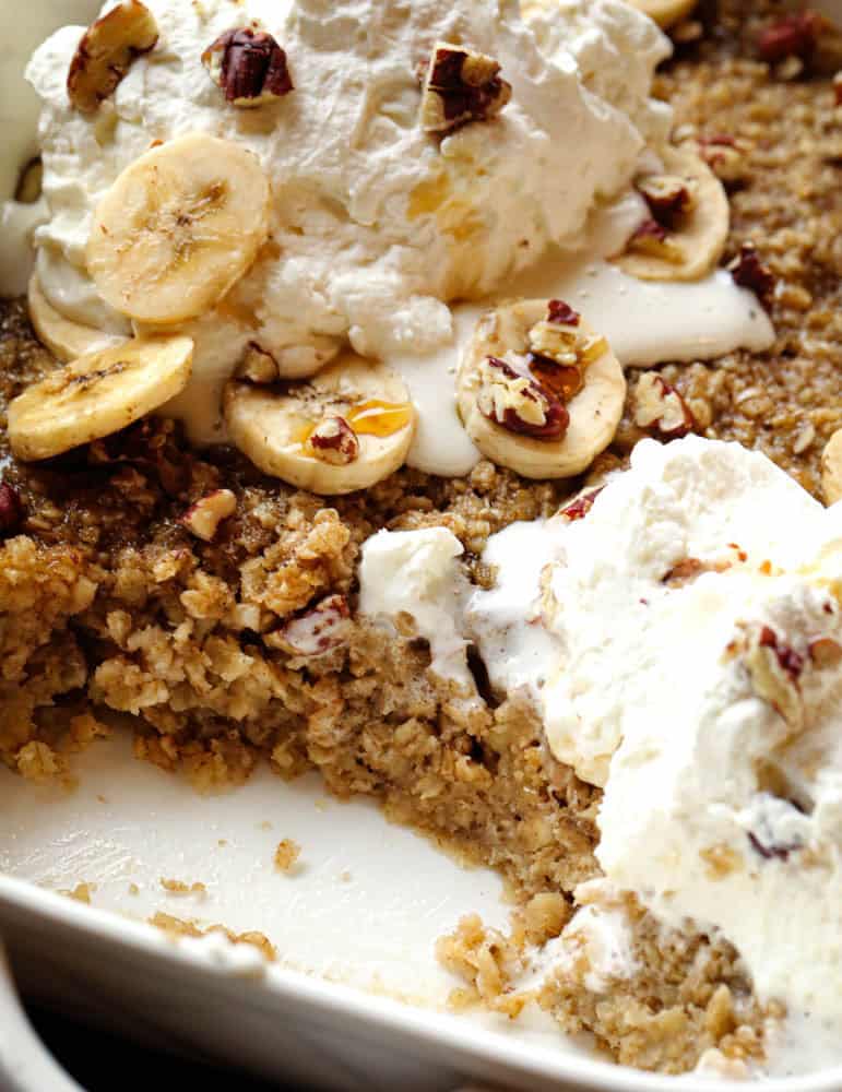 Scoop taken from baked banana oatmeal showing the soft, creamy oat texture inside the dish