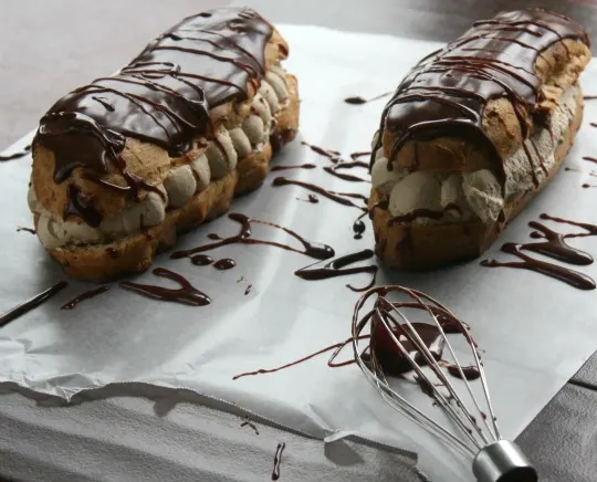 Recipe for Coffee Cream filled Eclairs with Kahlua Chocolate Glaze. A decadent Eclair with coffee whipped cream and a Kahlua infused chocolate glaze.