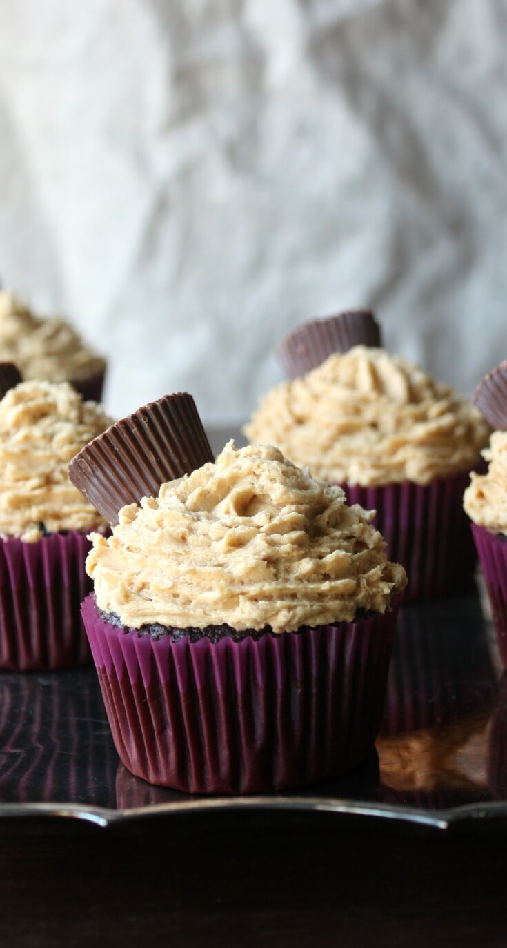 Chocolate Peanut Butter Cupcakes recipe topped off with mini peanut butter cups candy. Rich chocolate cake with a fluffy peanut butter frosting recipe.
