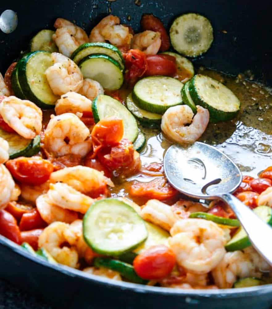 Skillet Shrimp with Vegetables Garlic Shrimp and Zucchini sautéed in a pan with fresh cherry tomatoes.
