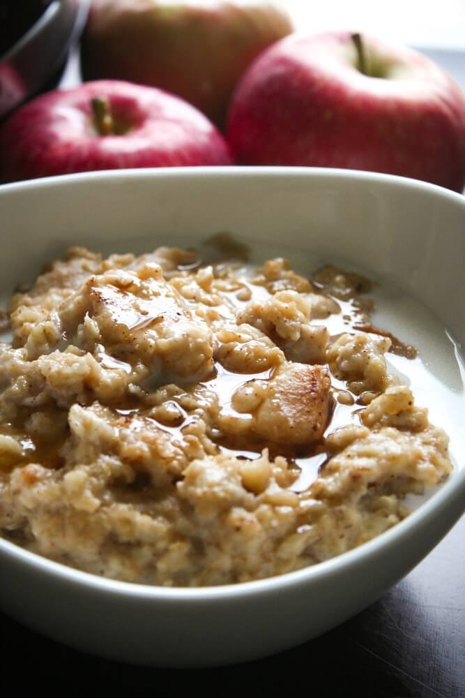 Crock Pot Oatmeal with Apples and Cinnamon with milk and maple syrup drizzled over the top is a warm and comforting breakfast.