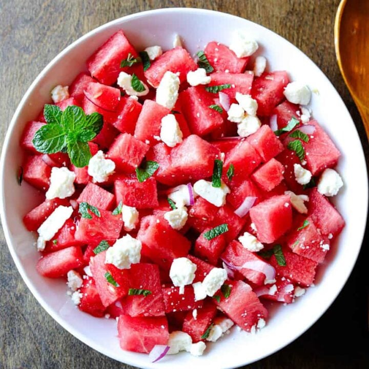 A bowl of watermelon salad with feta cheese and mint.