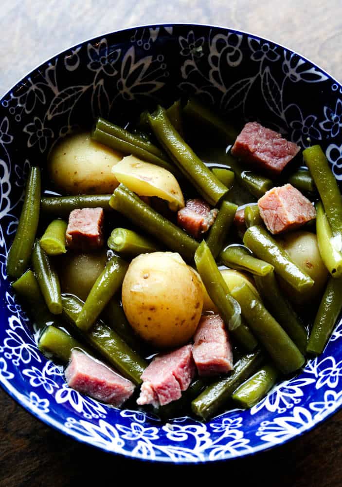 Green beans, ham, and potatoes cooked in the crock pot and served warm in a rustic bowl